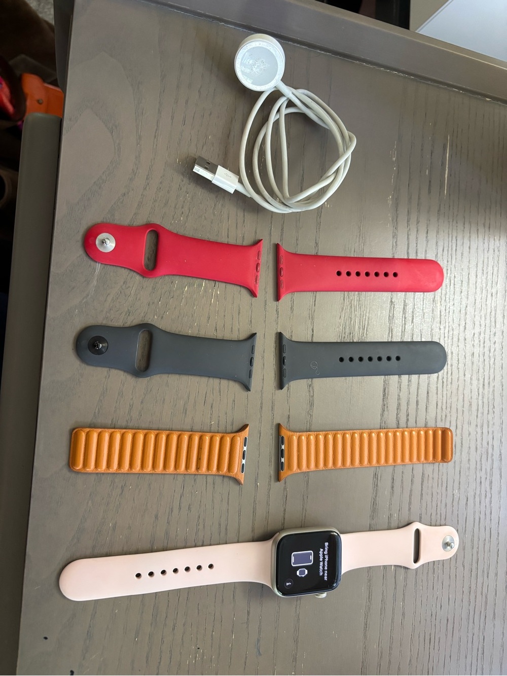 Apple Watch with Pink Band and Red, Black, and Orange Strap Set